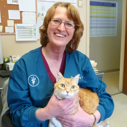 Cathy Glahn  holding an orange tabby cat